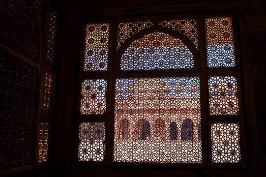 Looking through a marble latticework jali into the quadrangle of the Jama Masjid in Fatehpur Sikri.