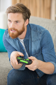 man playing videogames on the sofa