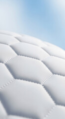 Fototapeta premium Close-up of white quilted fabric texture, featuring stitched seams. Represents softness, comfort, and luxury, ideal for furnishing or design concept