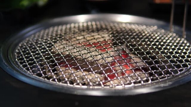 Place the barbecue grill in the hood at a Korean restaurant. High quality 4k footage