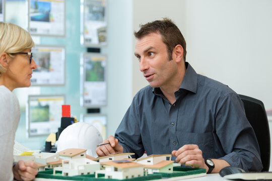 estate agent looking at model development with customer