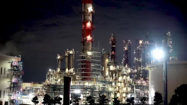 Night view of  industrial complex with glowing refineries