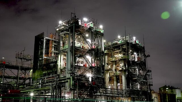 Night view of  industrial complex with glowing refineries