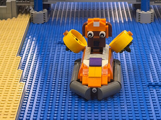 Obraz premium Orange lego animal boat on blue baseplates