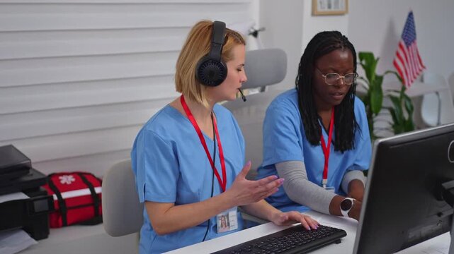 Two female medical operators working in a call center in the USA