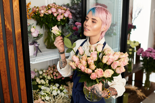 Young woman florists creates beautiful arrangements in her charming flower shop