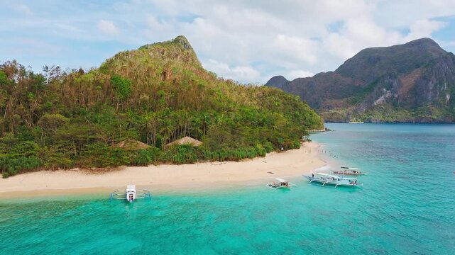 Island hopping boats at Helicopter Island beach El Nido Palawan Philippines