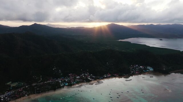 Sunset rays over El Nido town and Bacuit Bay Palawan Philippines coastline