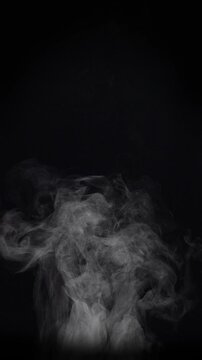 White natural rising steam from food or hot drink isolated on a black background. Сan be used in any projects with hot food.