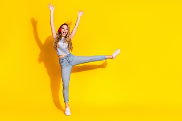 Young blonde woman with a cheerful expression enjoying leisure time in trendy casual fashion...