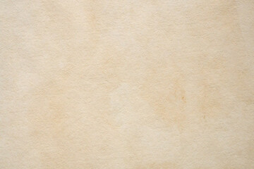 Old vintage paper texture background with aged stains and antique yellowed parchment effect