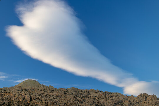 Wide landscape of El Yelmo mountain in La Pedriza with clear sky and natural rocky textures.