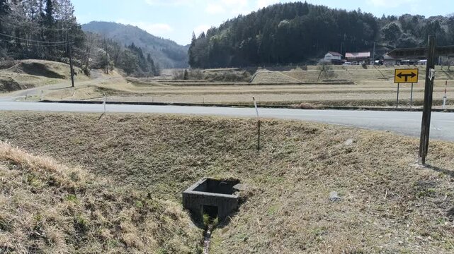 Quiet rural countryside landscape with gentle water stream and birds chirping in Japan
