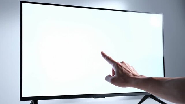 Hand interacting with a blank smart screen digital display, representing interactive control, modern technology, and user experience for various applications like information display or futuristic...