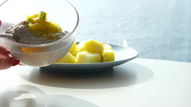 Chia seeds with cream yogurt stirring with spoon. Chia pudding healthy snack