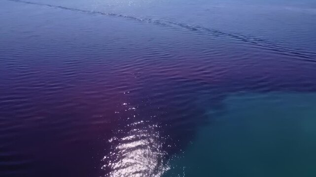 Aerial View of Two Toned Ocean Water With Sun Reflection and Boat Wake
