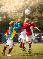 Fototapeta premium Boys kicking football on the sports field