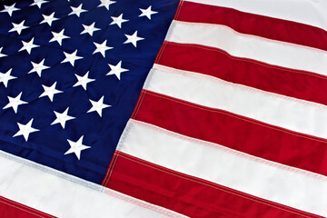 Obraz premium A detailed, close-up perspective of the United States flag, highlighting the texture and stitching of its iconic stars and stripes pattern