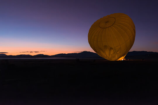 Prepping the hot air balloon at sunrise in Mareeba in the Atherton Tablelands