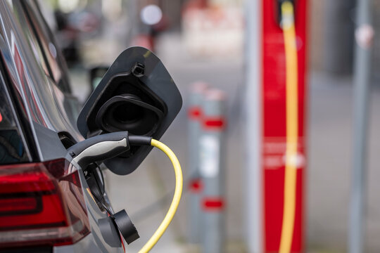 Close up of electric vehicle charging plug and cable in Hamburg highlighting sustainable energy mobility and transport transition