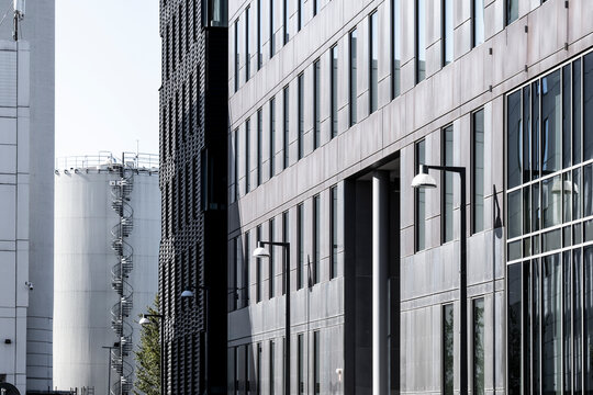 Glass and steel modern building facade with repeating windows and minimal urban architectural perspective
