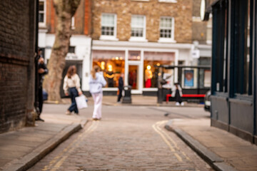Blurred London High Street Shops – Narrow Alley Leading to Retail Shopping Scene Concept