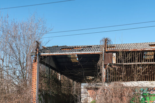 Asbestos cement roof with damaged eternit panels, hazardous material removal, environmental risk concept, industrial building renovation, toxic exposure danger, construction safety and pollution issue