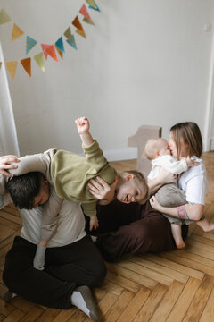 Happy family celebrating milestone and playing together indoors