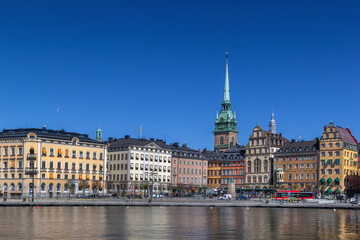 Fototapeta premium View of Kornhamnstorg square and old town colorful buildings from the water in Stockholm, Sweden. Clear blue sky in April