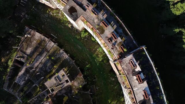 Drone View of Abandoned Soviet Architecture Hidden in Forest Near Sea