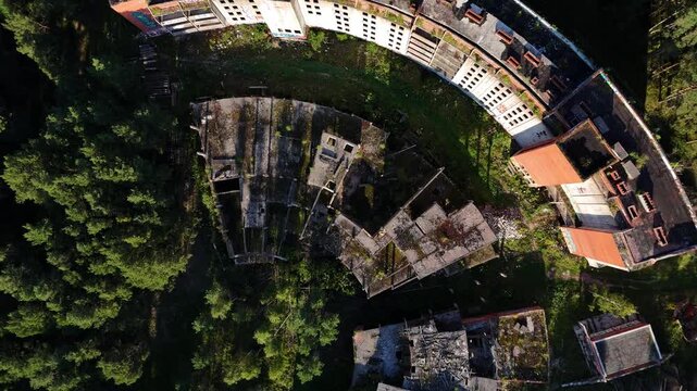 Drone Flyover Abandoned Soviet Concrete Hotel Ruins Near Forest and Sea