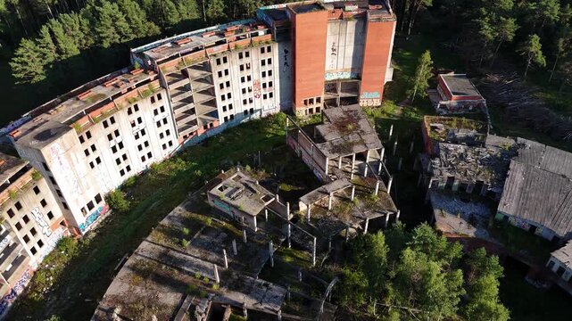 Drone Flyover Abandoned Soviet Concrete Hotel Ruins Near Forest and Sea