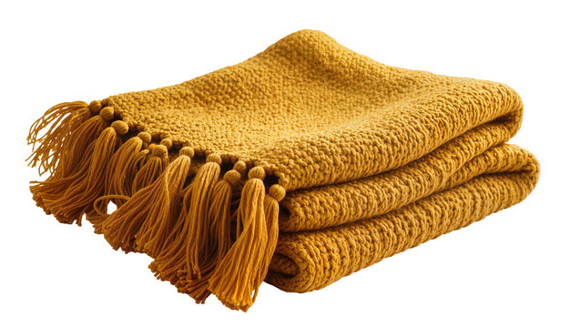 Isolated beautifully folded mustard yellow knitted blanket with decorative tassels, cozy home textile