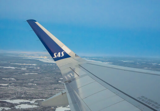Sas airplane wing view over snowy landscape