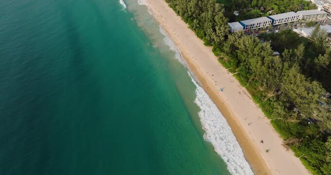 Tropical Coastline Of Nai Thon Beach In Phuket, Thailand, With Lush Green Trees And Coastal Resorts. aerial tilt-up shot