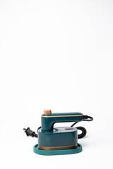Fototapeta premium Teal Handheld Travel Steamer with Cork Knob on Base on a white background