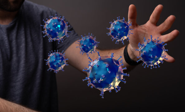 Man's hand reaching for 3D rendered virus in concept about the pandemic, contagion, spread of germs, disease a