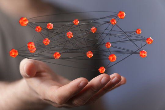 An abstract, interconnected network of digital objects is held in a human hand, representing connectivity, technology,