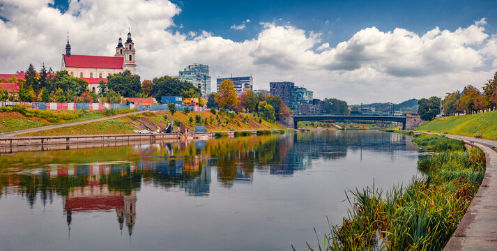 Panoramic autumn view of Church of St. Archangel Raphael. Nice morning cityscape of Vilnius, Lithuania, Europe. Wonderful outdoor scene of Neris river. Traveling concept background.
