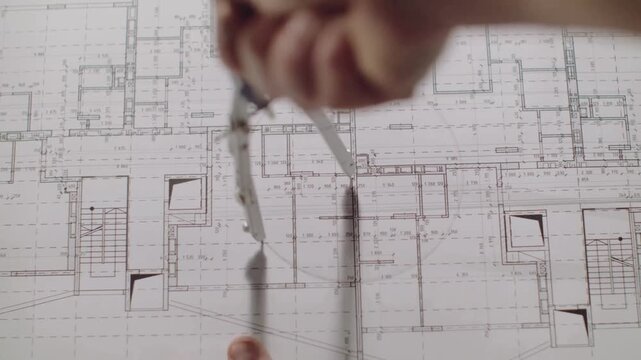 Plan blueprint close-up. Architect Engineer Makes Drawing Of Circle Line On Plan. Architect drawing, professional engineer working, interior creator making architectural project, drafting building.
