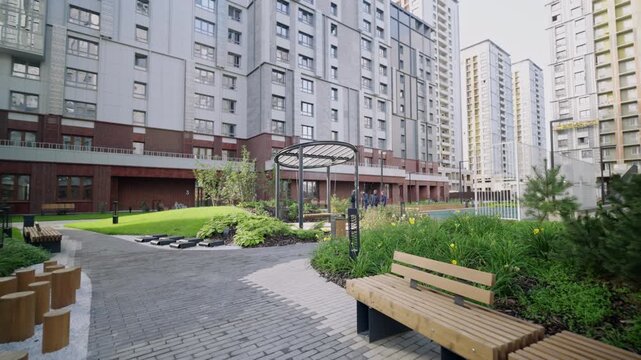Recreation territory for residents equipped with benches walking paths gazebos and lawns. Courtyard designed for social outdoor activity