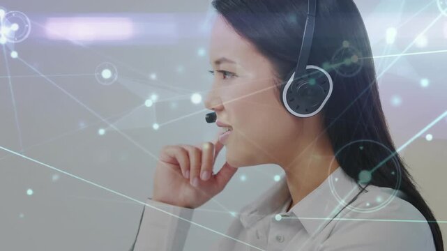 Animation of network of connections over asian businesswoman wearing phone headset