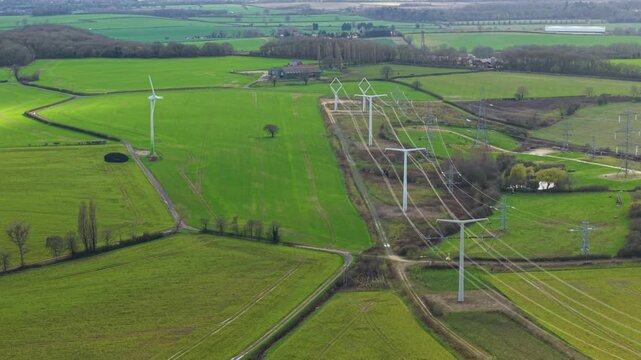 High angle aerial view of modern T-pylon electrical high voltage lines at the National Grid training facility in Eakring United Kingdom.