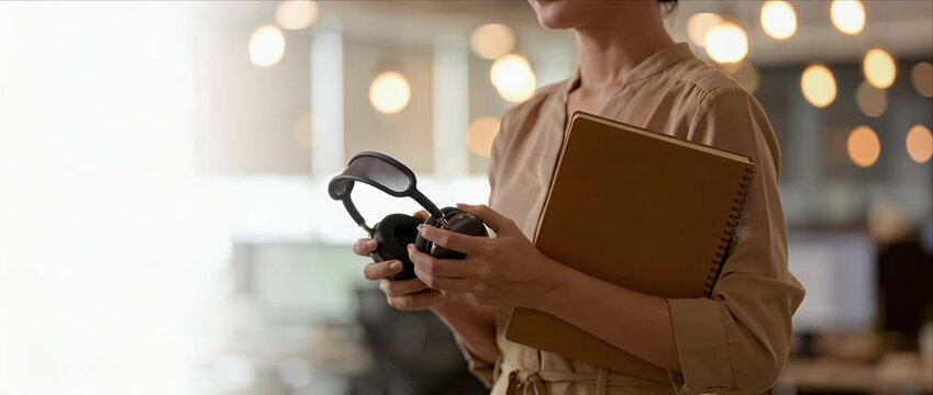 Business woman office female professional workplace coworking headphone notebook casual clothing soft light modern interior bokeh background smiling woman headset office asian female employee holding