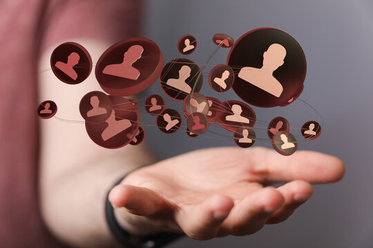 Abstract image of a network of people or social connections floating above an open hand, representing community and coll