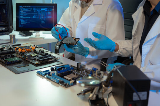 Hands repairing electronic devices. Electronic technician.