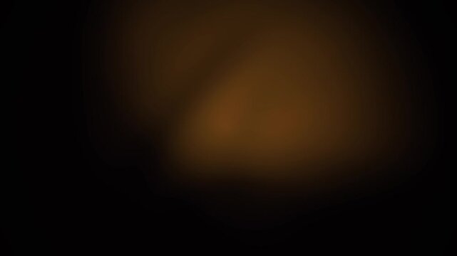 Blurry orange light on black background.