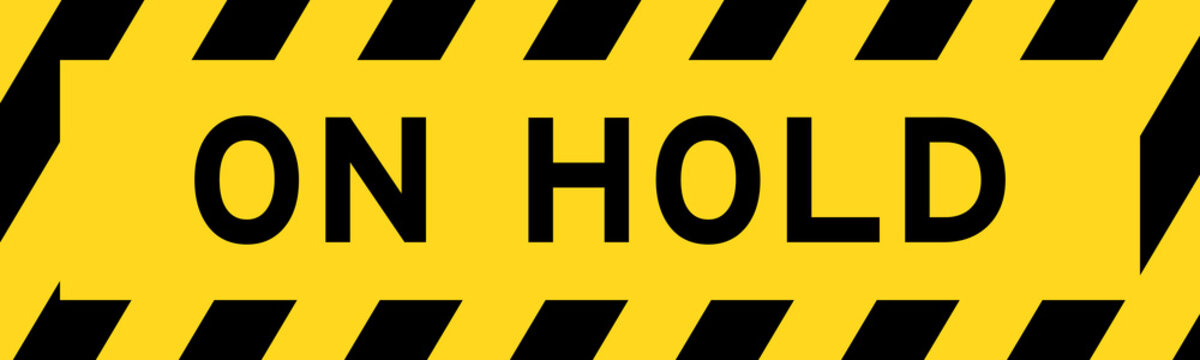 Yellow and black color with line striped label banner with word on hold