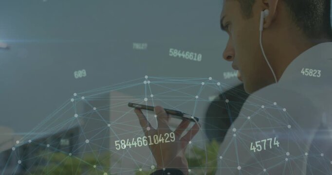 A man is talking on his mobile phone while walking down the street