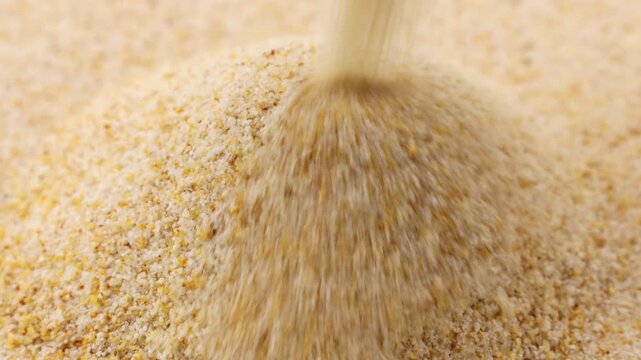 Dried granulated garlic falling down close up